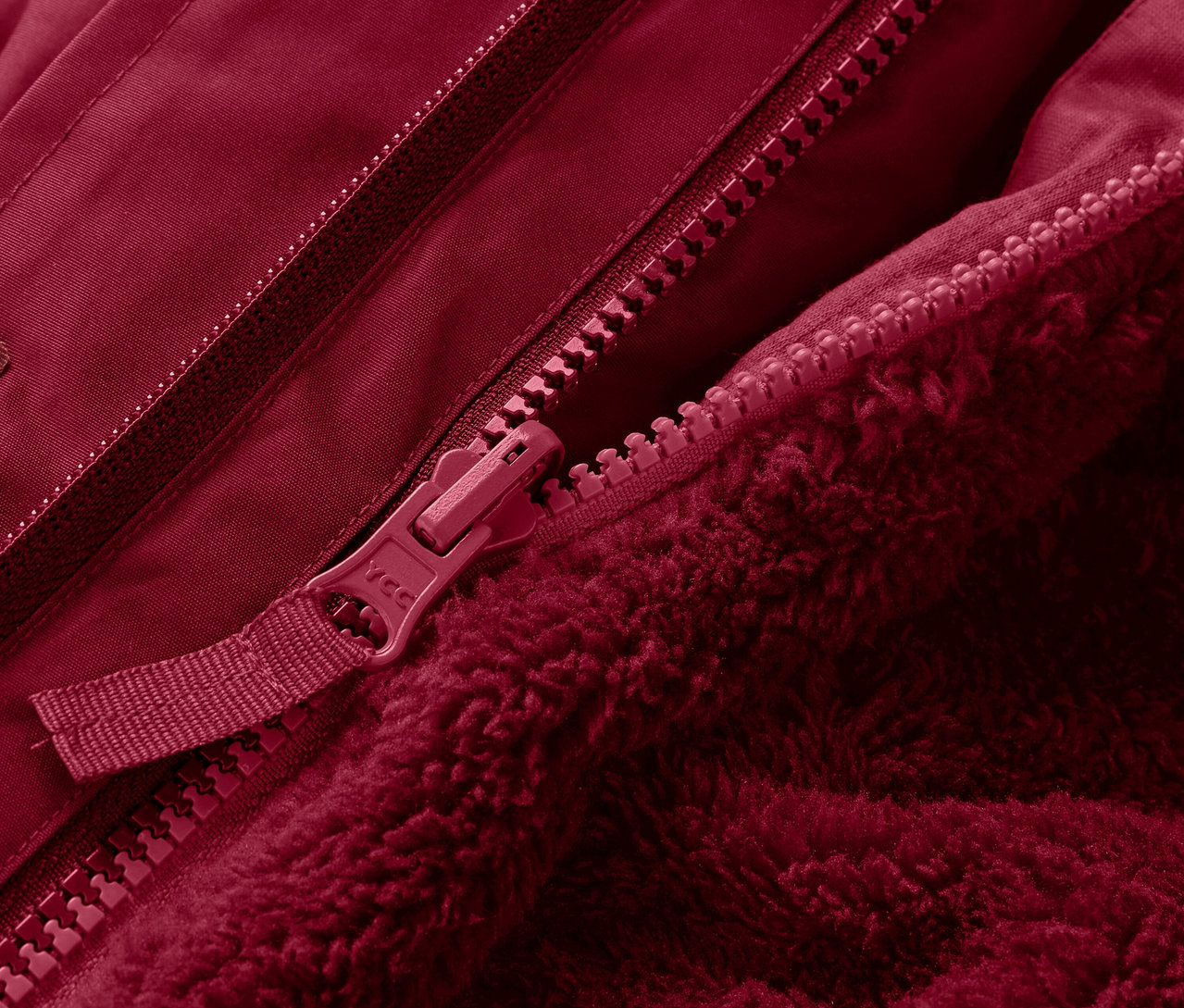 Detail červené 3-in-1 dětské zimní bundy se zipem.