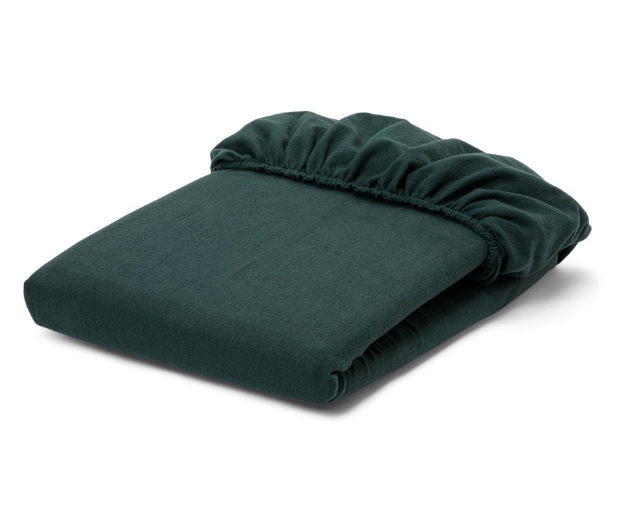 Složená zelená napínací prostěradla na bílém pozadí.