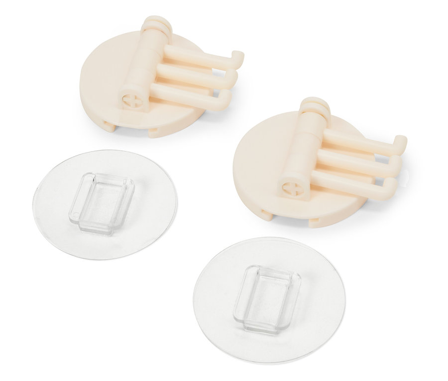 Dva béžové držáky s třemi háčky a průhlednými nalepovacími podložkami.