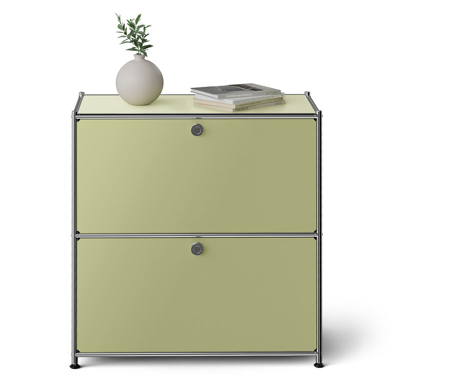 Zelená skříňka se dvěma zásuvkami. Na horní desce váza a kniha.