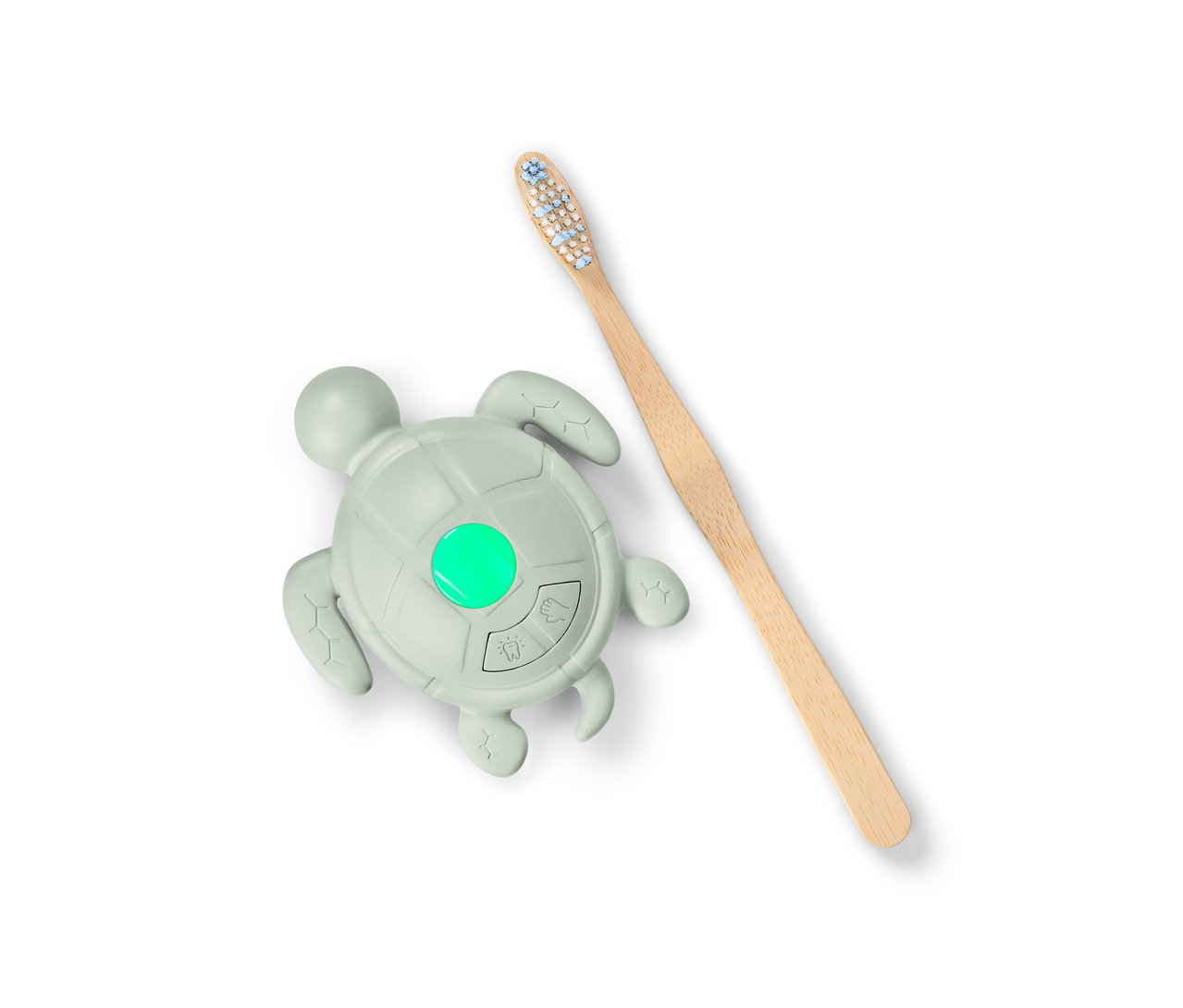Časovač na mytí rukou a čištění zubů ve tvaru želvy se zeleným světlem a dřevěný kartáček na zuby.
