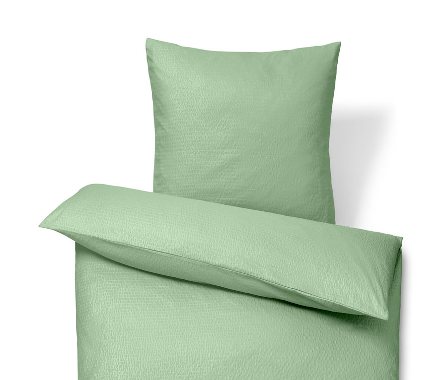 Zelené krepové povlečení standardní velikosti a krepové povlečení nadměrné velikosti.