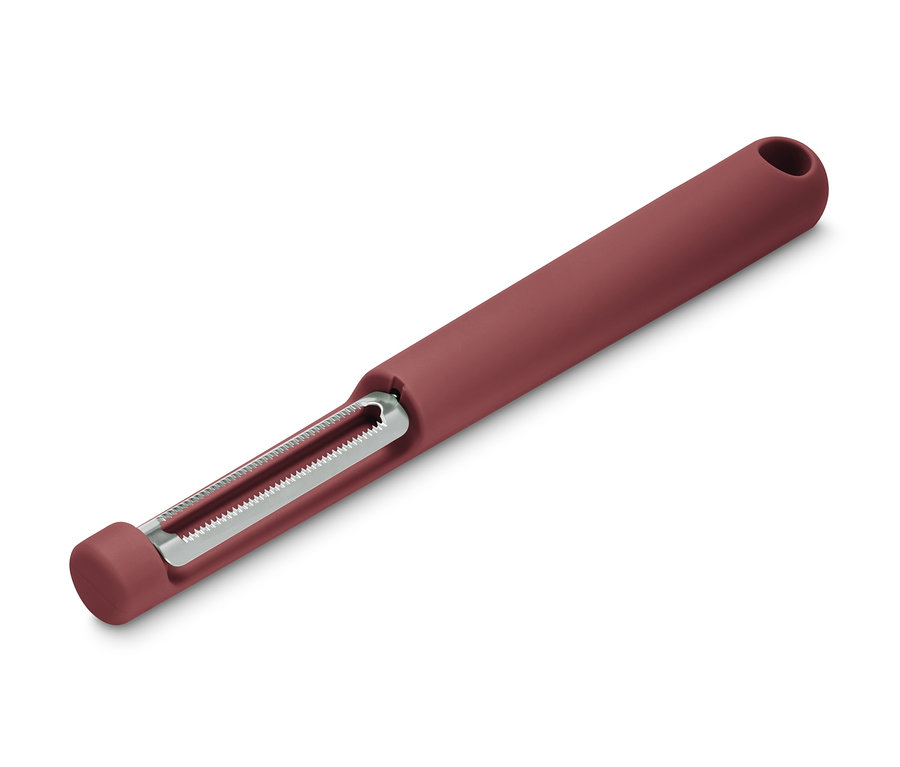 Detail univerzální škrabky s červenou rukojetí a stříbrnou čepelí na bílém pozadí.