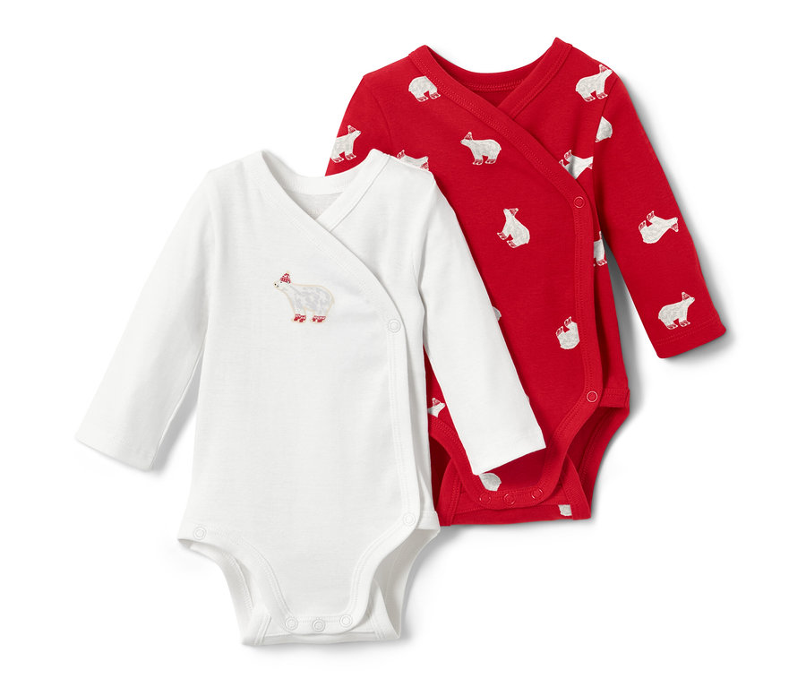 Dvě dětská body s dlouhým rukávem: bílé s motivem ledního medvěda a červené s potiskem ledních medvědů.