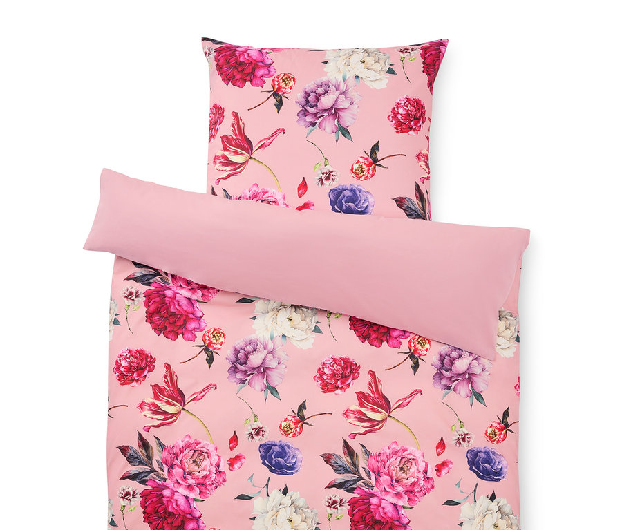 Ložní prádlo s květinovým vzorem v růžové barvě, skládající se z povlaku na polštář a povlaku na přikrývku.