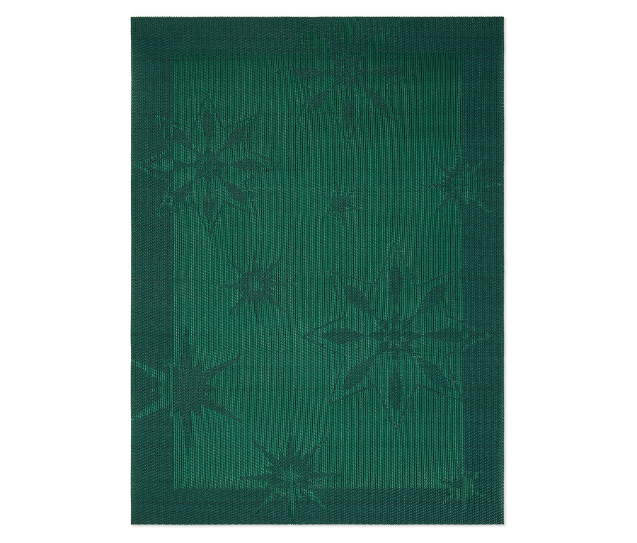 Detailní pohled na zelený textilní prostírání s motivem hvězdy.