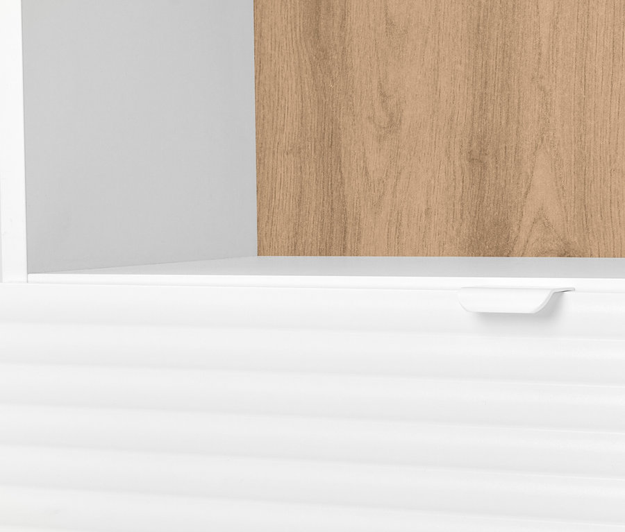 Detailní pohled na bílou skříňku se zásuvkou a dřevěnou policí.