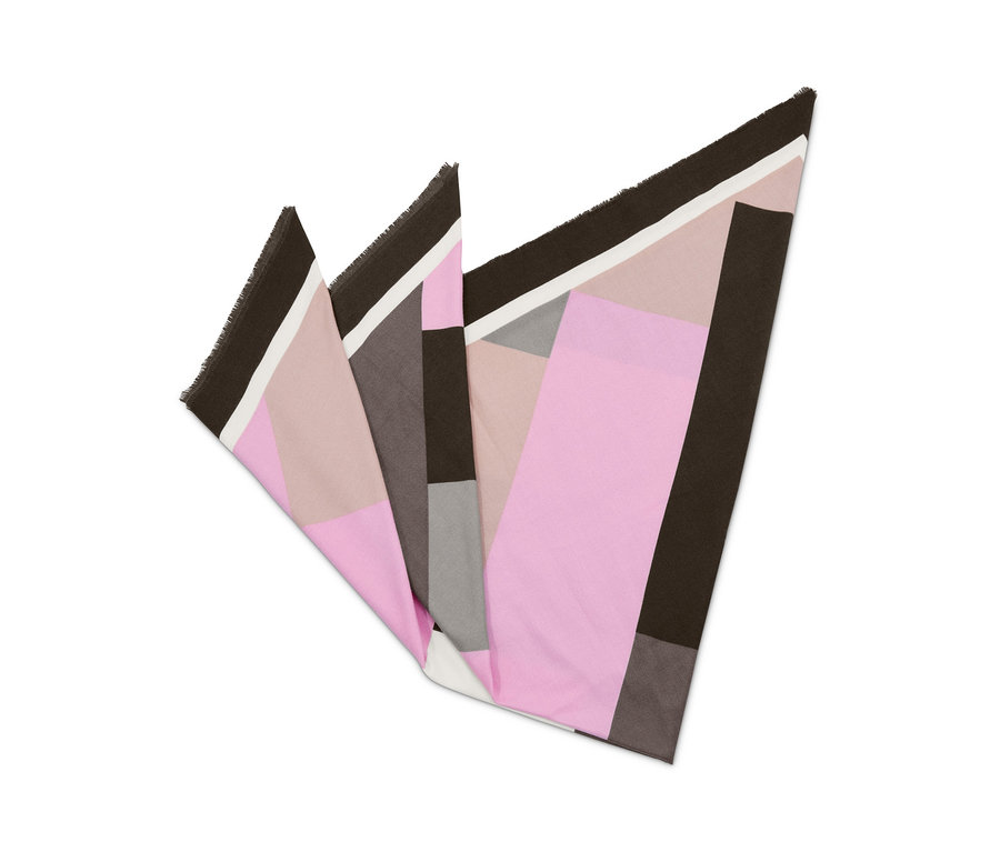 Detail of a folded šála with pink, gray, and brown geometric pattern.