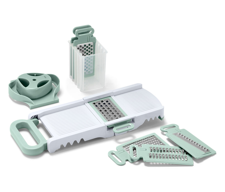 Sada kuchyňských kráječů a struhadel s bílým tělem a světle zelenými detaily.