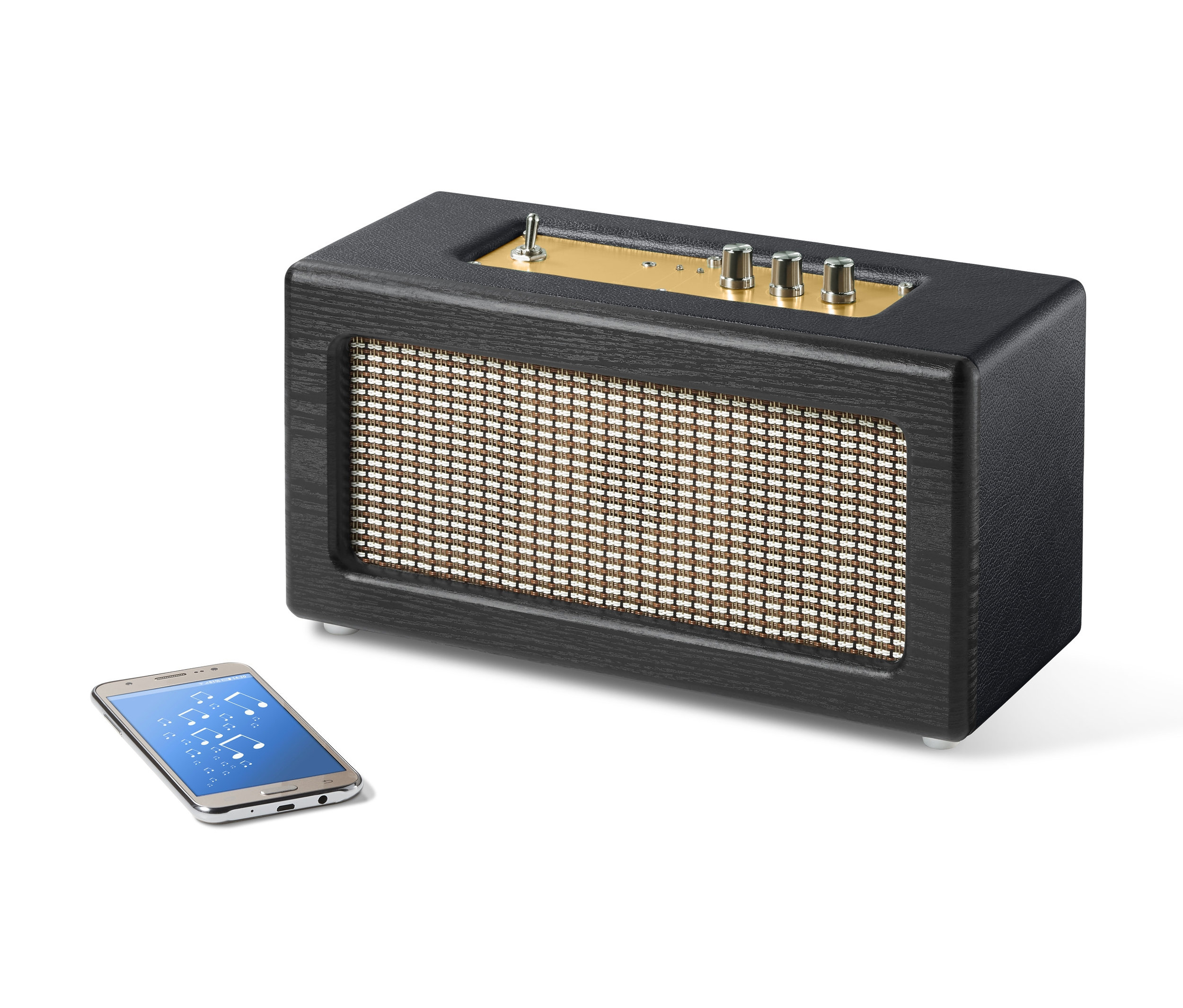 Černý retro reproduktor s Bluetooth® vedle smartphonu.
