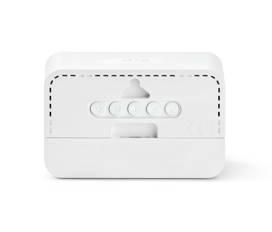 Detail zadní strany digitálního LCD budíku s ovládacími tlačítky.