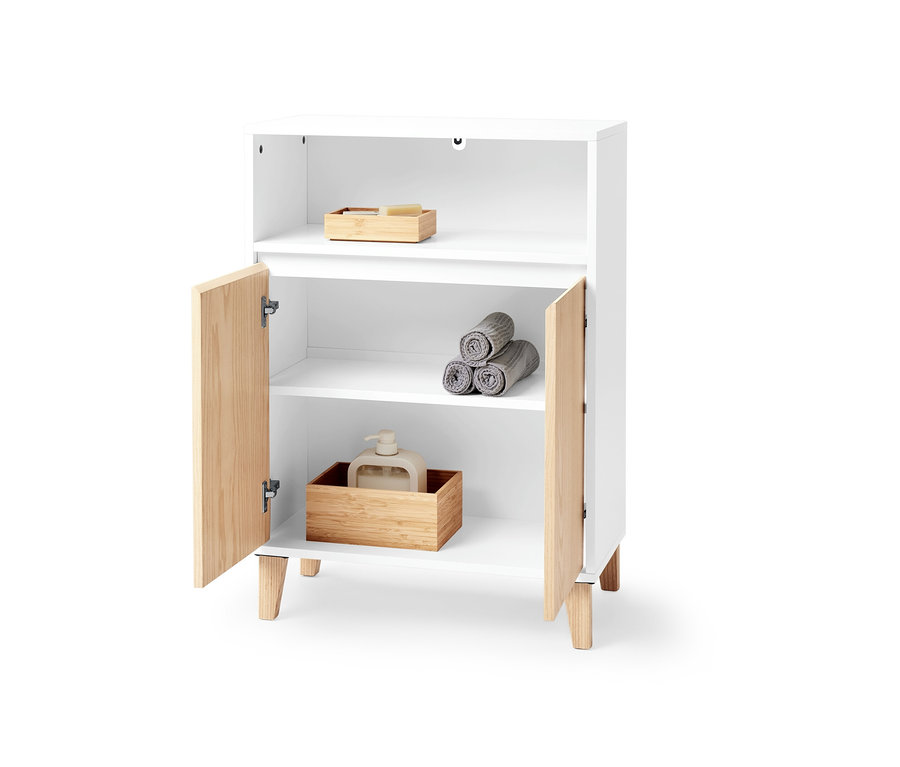 Bílá odkládací skříňka se dvěma dvířky a otevřeným prostorem. Uvnitř jsou ručníky a dávkovač mýdla.