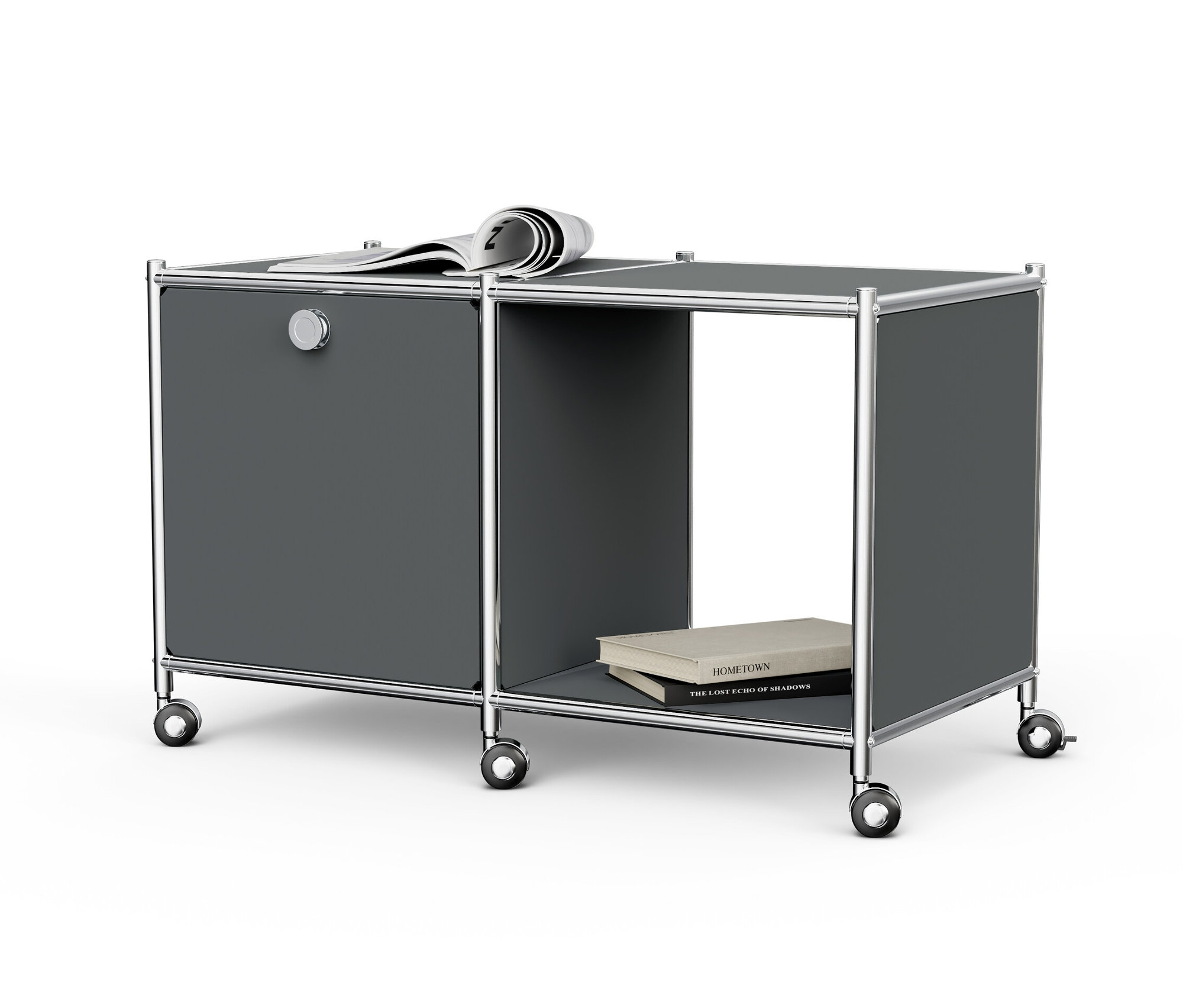 Šedý kovový odkládací stolek »CN3« s 1 výklopnými dvířky, kolečky a novinami nahoře a knihami v otevřené přihrádce.