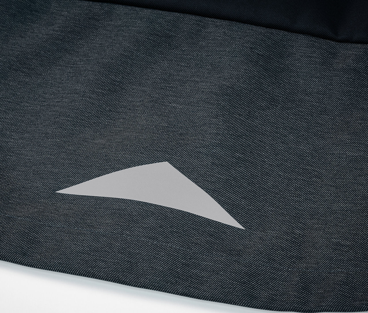 Detail dětské softshellové bundy s reflexním trojúhelníkem.