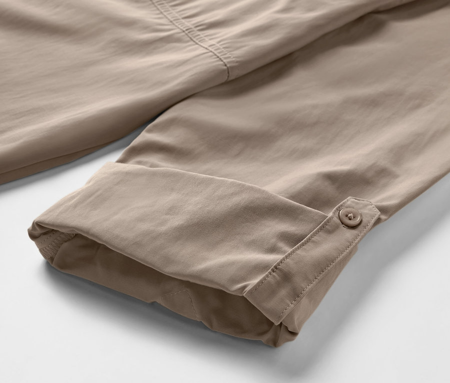 Detail béžové outdoorové košile s ochranou proti komárům a ohrnutými rukávy.