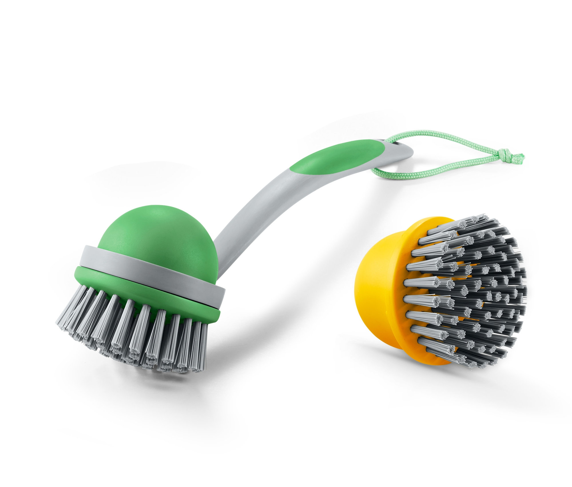 Štětka na mytí nádobí s vyměnitelnou hlavou 2 v 1 se zelenou rukojetí a žlutou vyměnitelnou hlavou.
