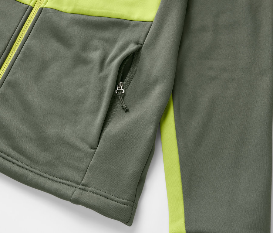 Detail šedé termobundy s limetkovými detaily a kapsou na zip.
