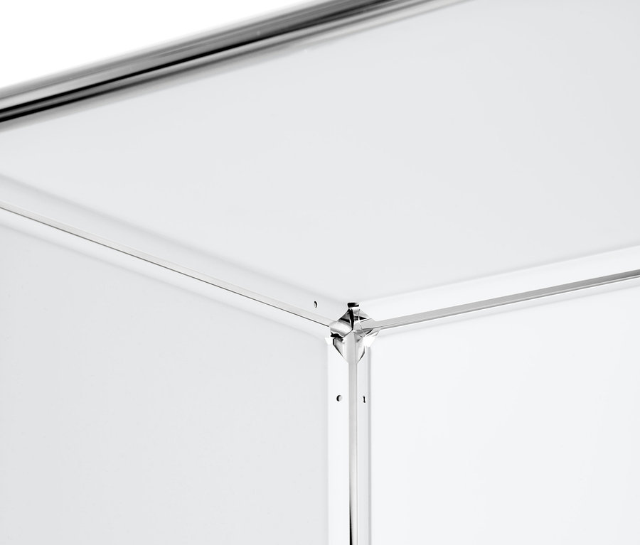 Detail rohu vysokého kovového regálu s přemístitelnými výklopnými dvířky.