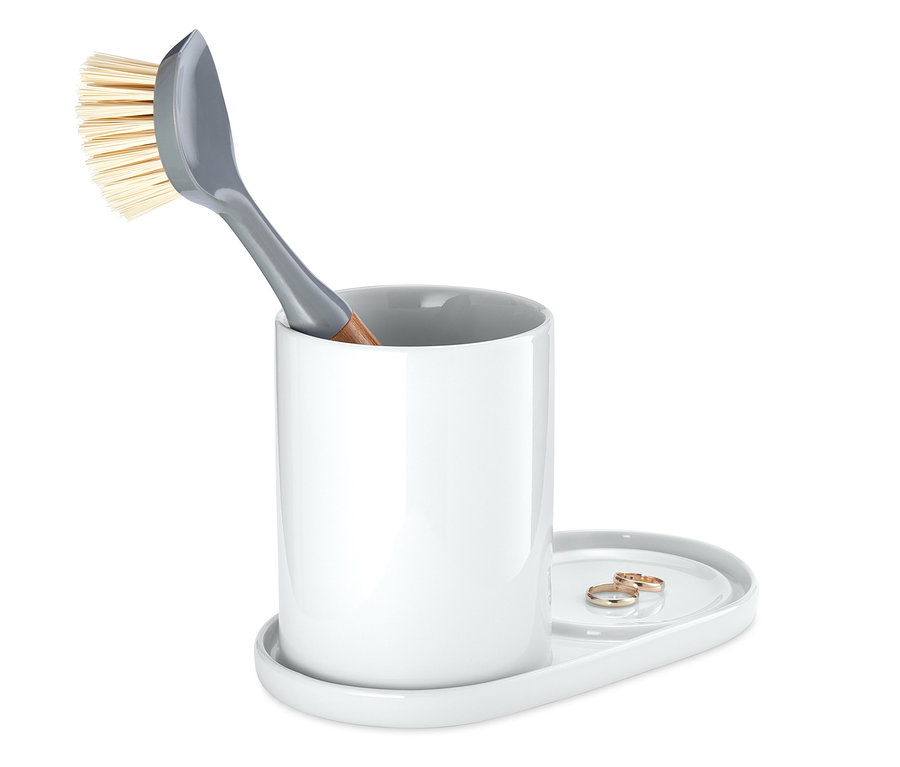 Šedý kartáč na nádobí v bílém organizéru na potřeby na umývání nádobí.