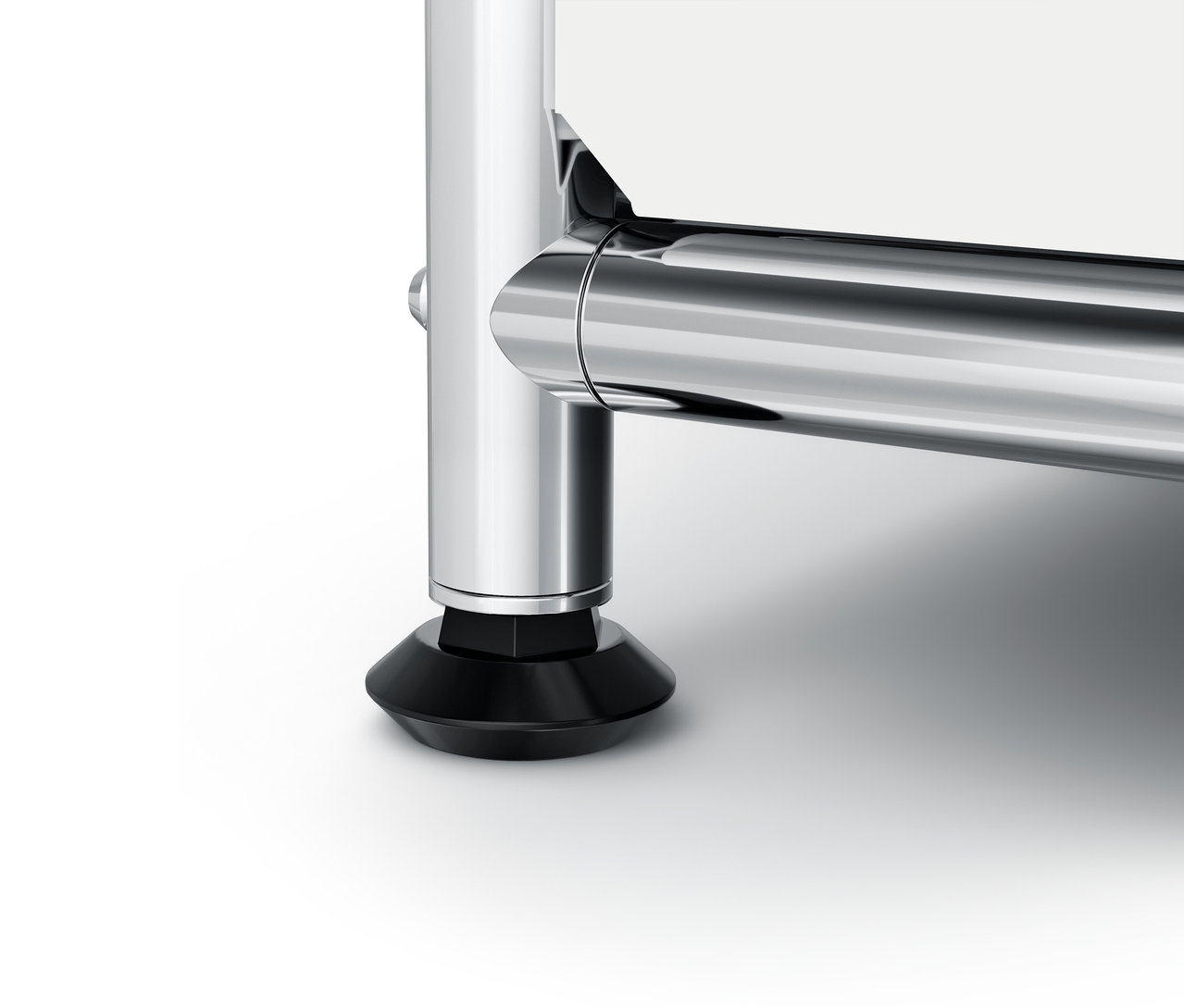 Detail chromované nohy nábytku s černou patkou.