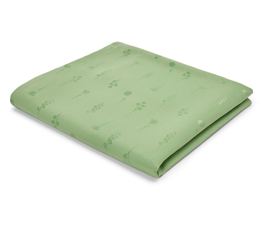 Světle zelený textilní ubrousek se vzorem stonků a květin.