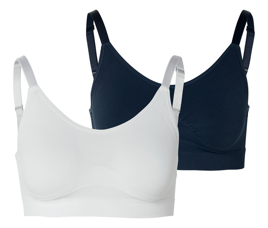 Dvě podprsenky, jedna bílá a jedna tmavě modrá, na bílém pozadí.