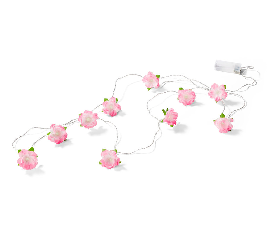 Světelný řetěz s LED s růžovými květy na bílém pozadí.