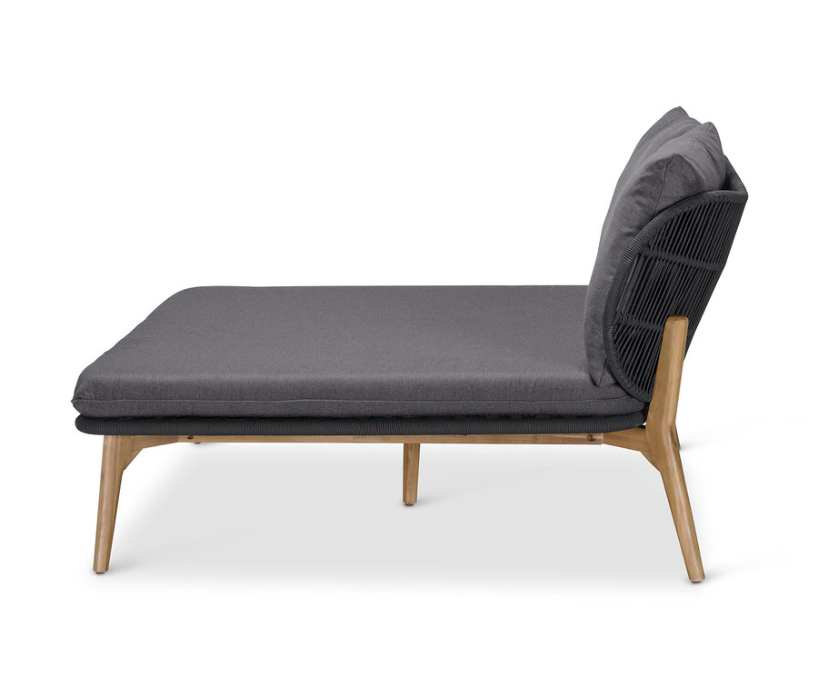 Boční pohled na pohovku na denní spaní s podhlavníkem a textilním výpletem.