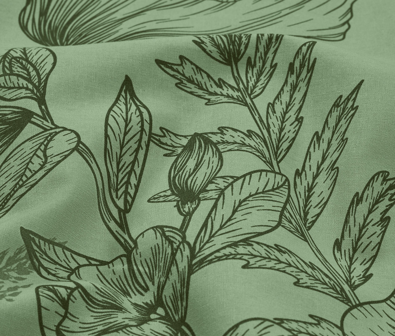 Detailní záběr na světle zelenou látku s tmavě zeleným květinovým potiskem.
