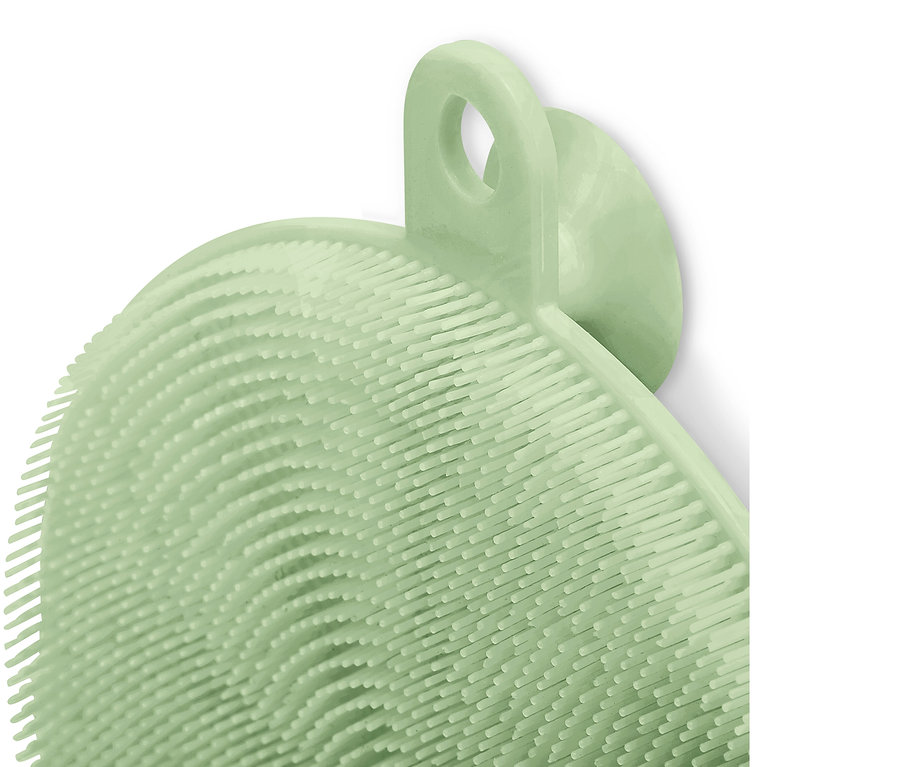 Detailní záběr na silikonovou mycí houbičku světle zelené barvy.