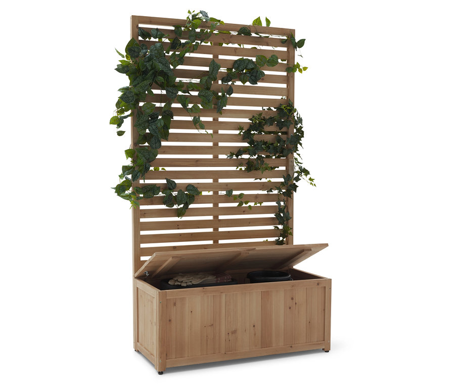 Dřevěná lavice s mřížkou a otevřeným víkem, pokrytá zelenými rostlinami.