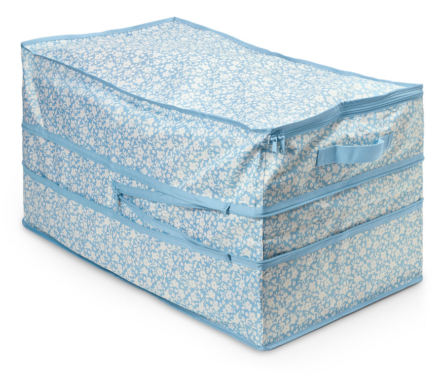 Velká úložná taška s modro-bílým květinovým vzorem a zipem.