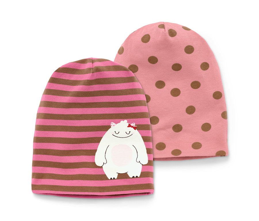 Dvě čepice: růžová s hnědými puntíky a růžová s hnědými pruhy a bílou našitou obludkou.