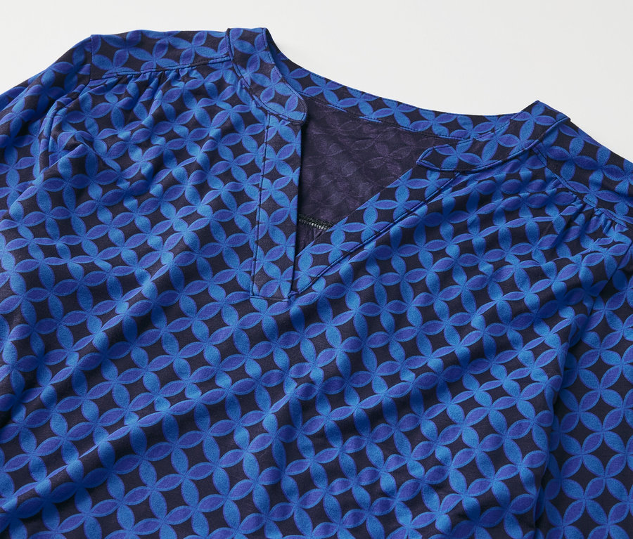 Detail of a cobalt blue patterned blouse shirt.