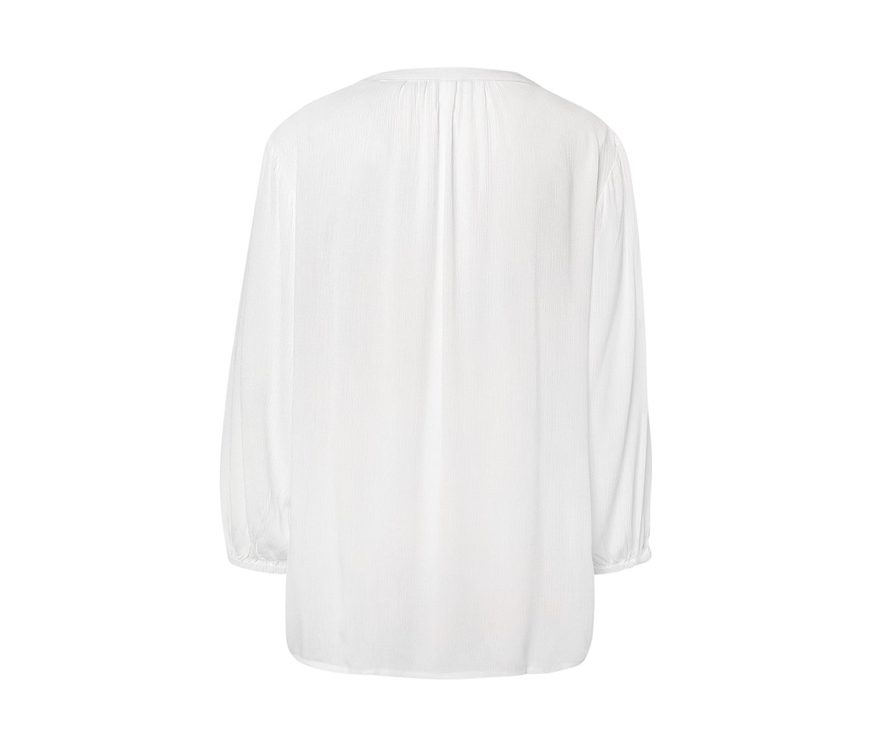 Detail bílé tunikové halenky.