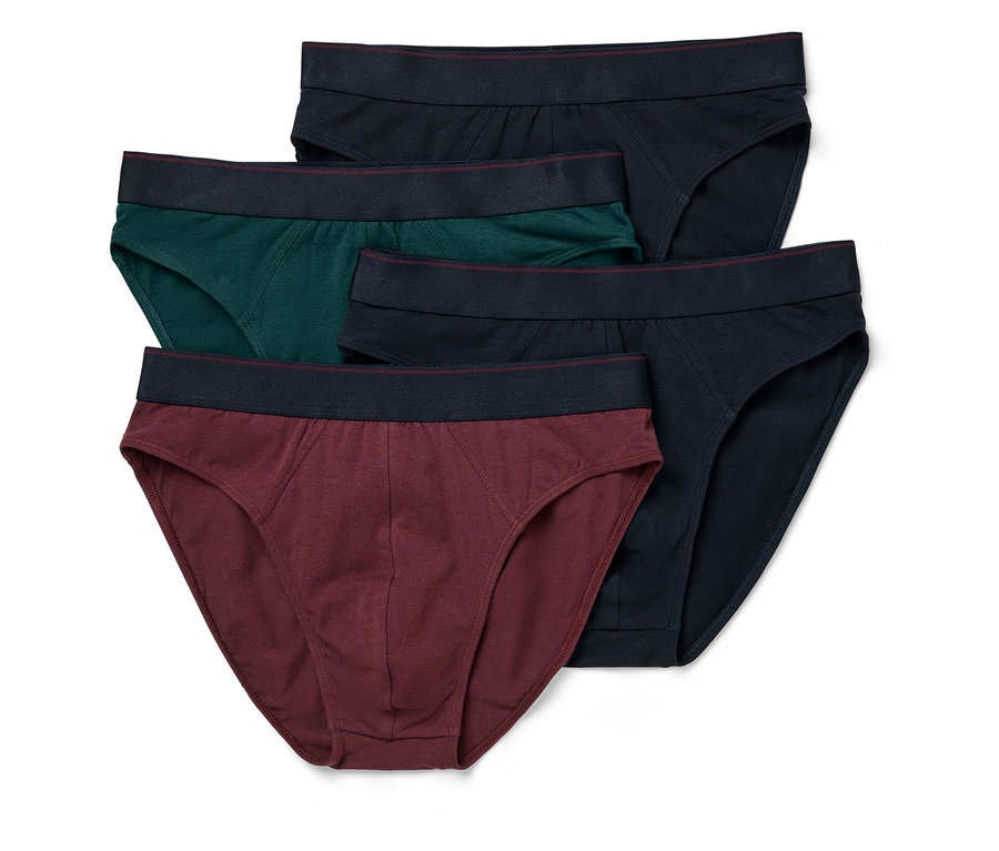 Pět pánských slipů v tmavě modré, zelené a vínové barvě leží na sobě.