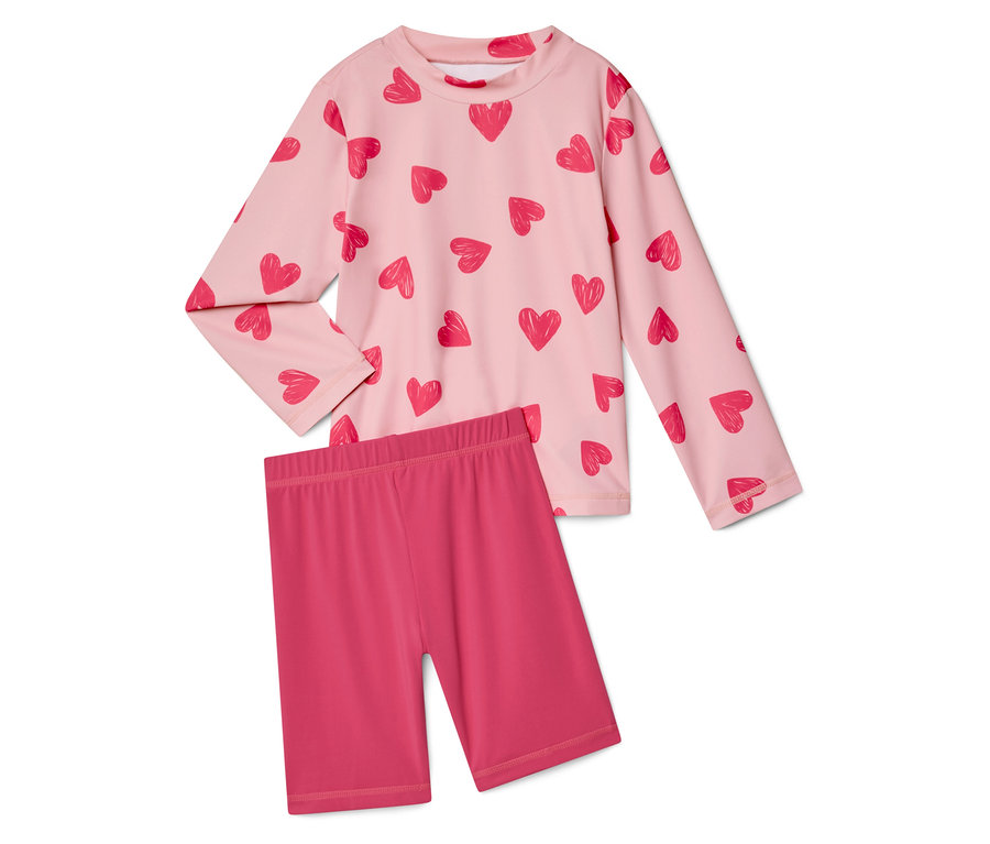 Růžový top s dlouhým rukávem se vzorem srdce a růžové krátké legíny.