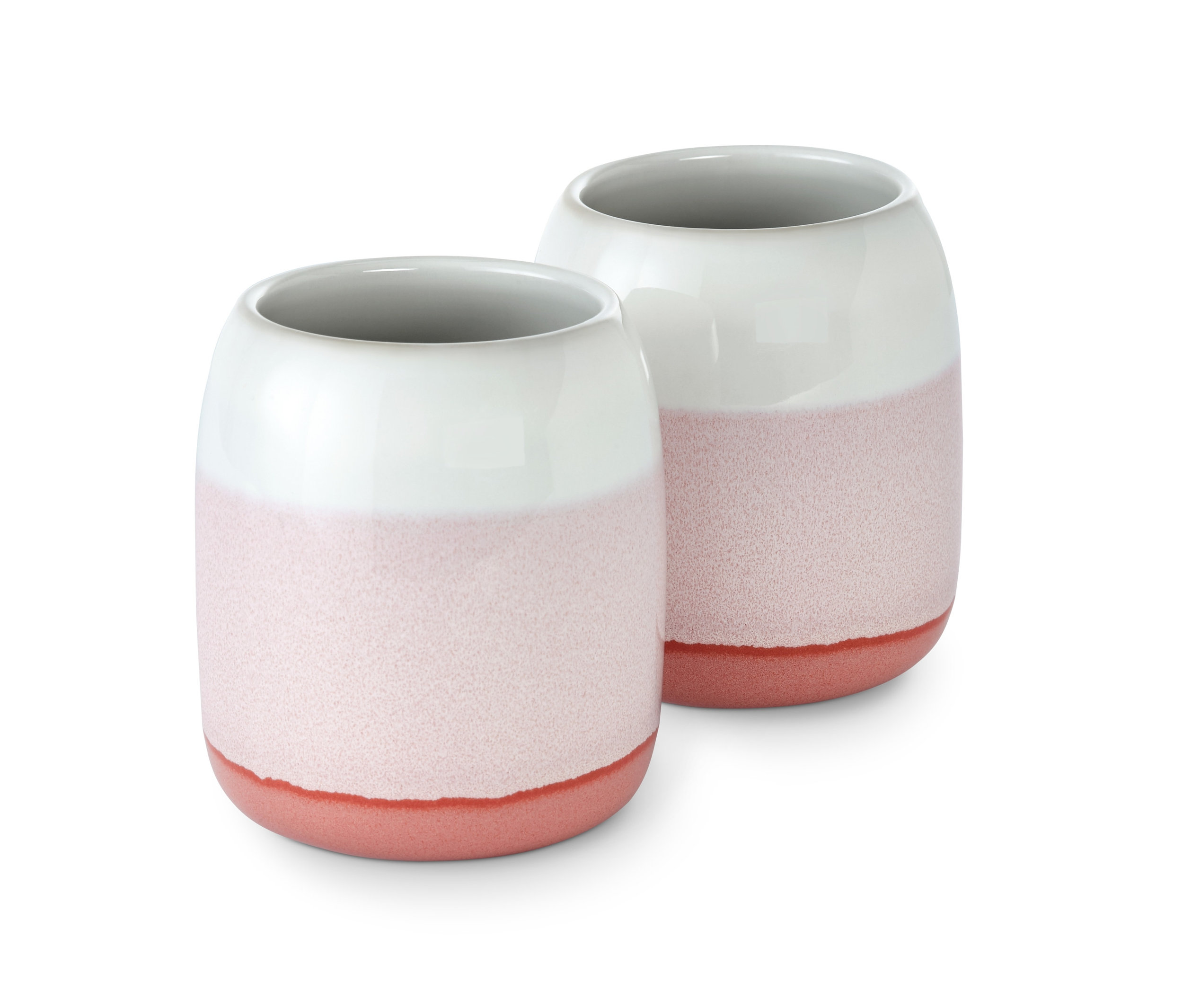 Dva kelímky na zubní kartáčky s bílým horním dílem a růžovým spodním dílem.