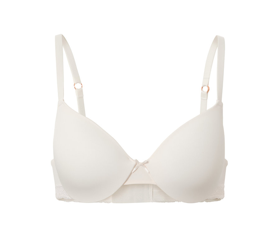 Krémová podprsenka pod tričko s mašličkou uprostřed.