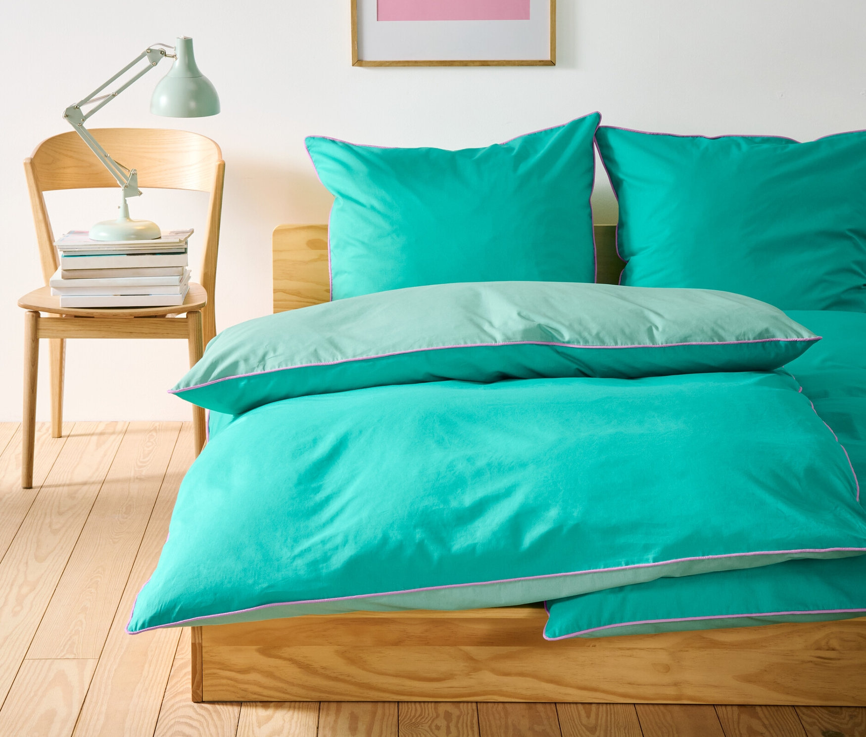 Na posteli leží tři standardní a jedna nadměrná sada povlečení renforcé.