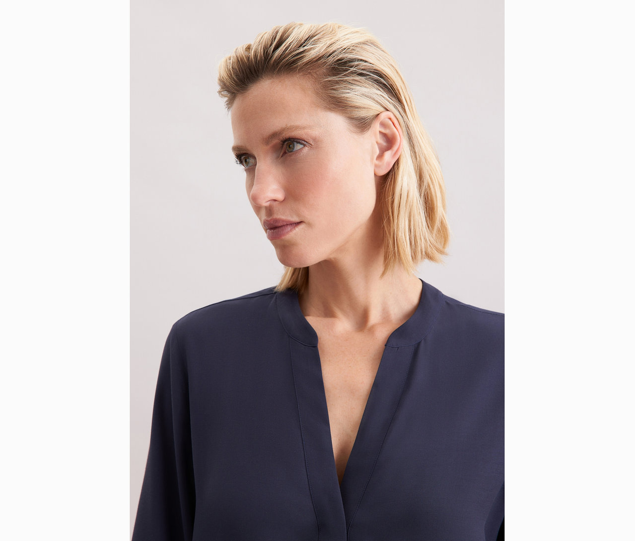 Žena má na sobě tuniku z viskózy Seidensticker, námořnická modrá.