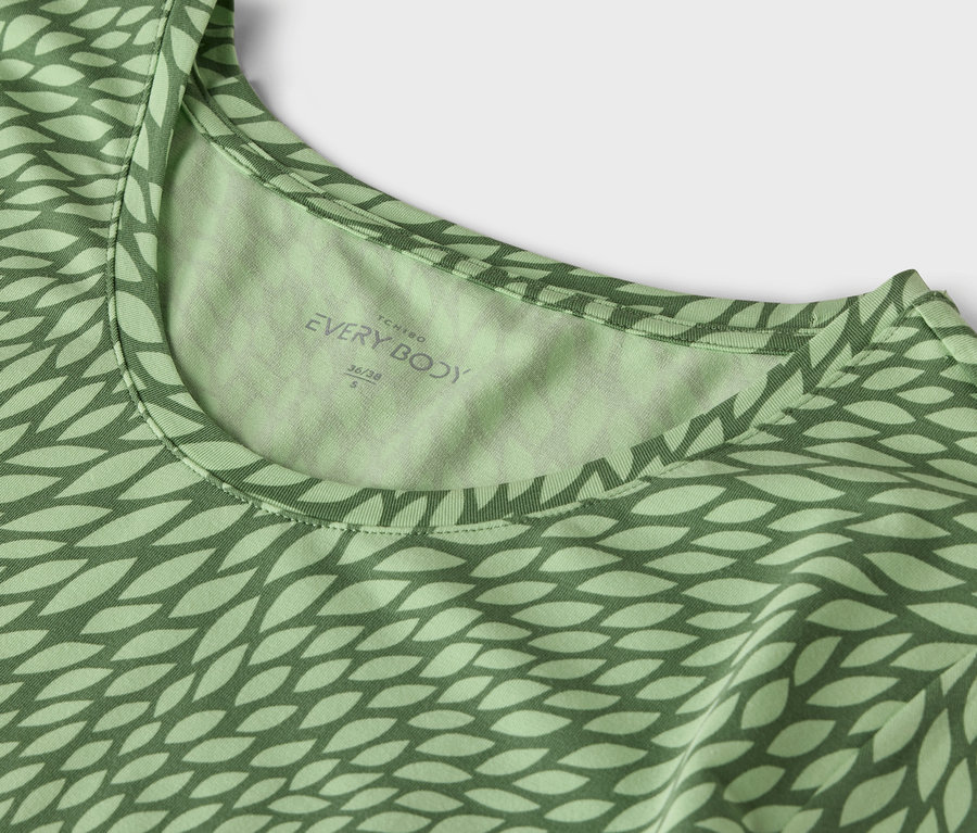Detail zeleného trička s potiskem.