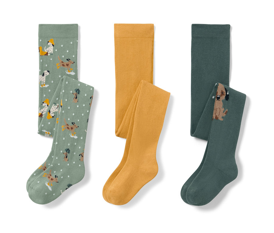 Tři dětské punčocháče: světle zelené s potiskem psů, žluté a tmavě zelené s obrázkem psa.