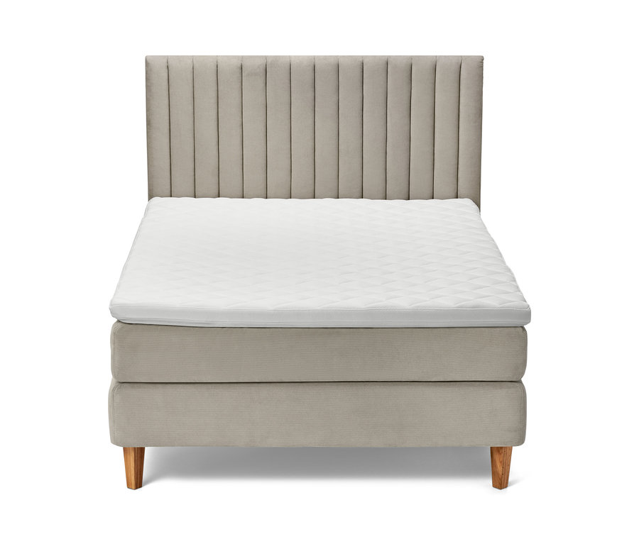 Béžová postel boxspring s čelem a bílou matrací.