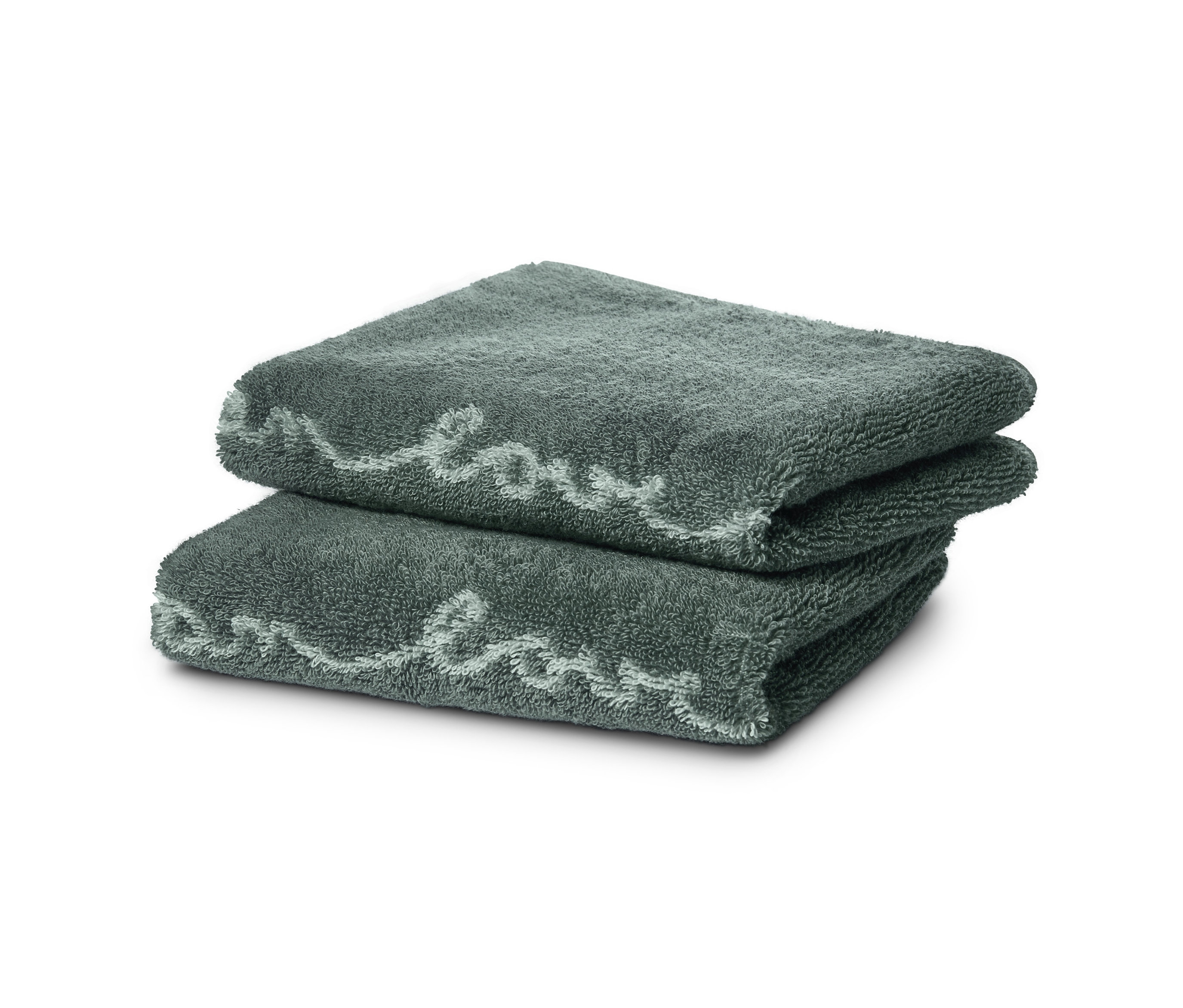 Dva žakárové ručníky pro hosty složené na sobě.