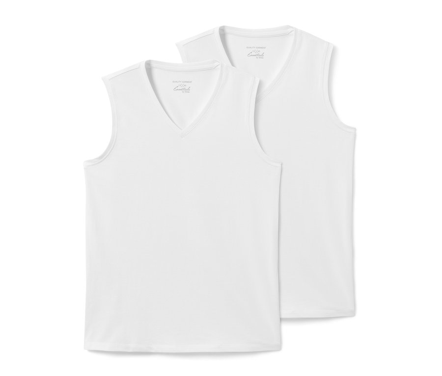 Dvě bílá letní tílka leží na sobě.