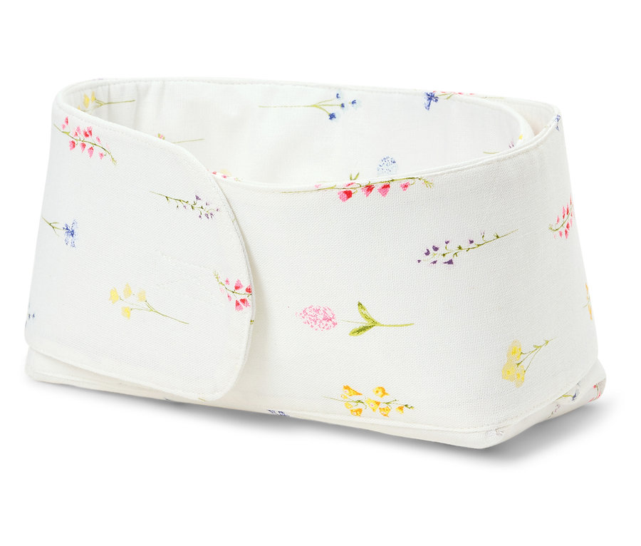 Bílý úložný box s květinovým vzorem.