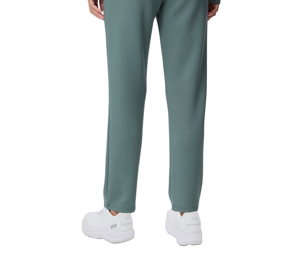 Pohled zezadu na osobu v dámských plazzo kalhotách FILA ze směsi modalu a bílých teniskách.