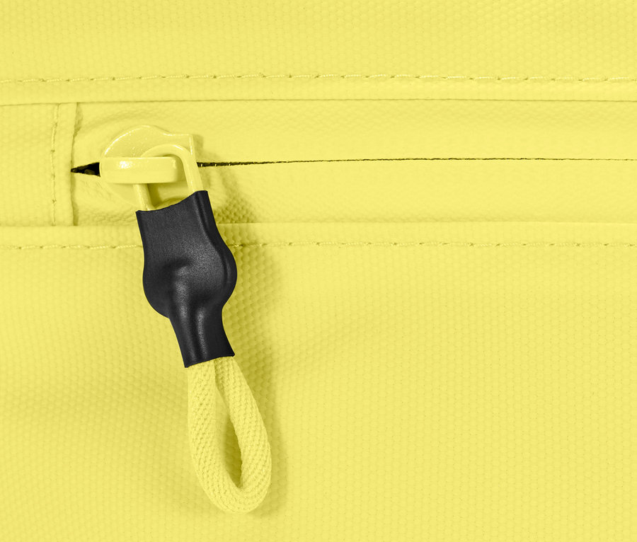 Detail žluté tašky přes rameno se zipem.