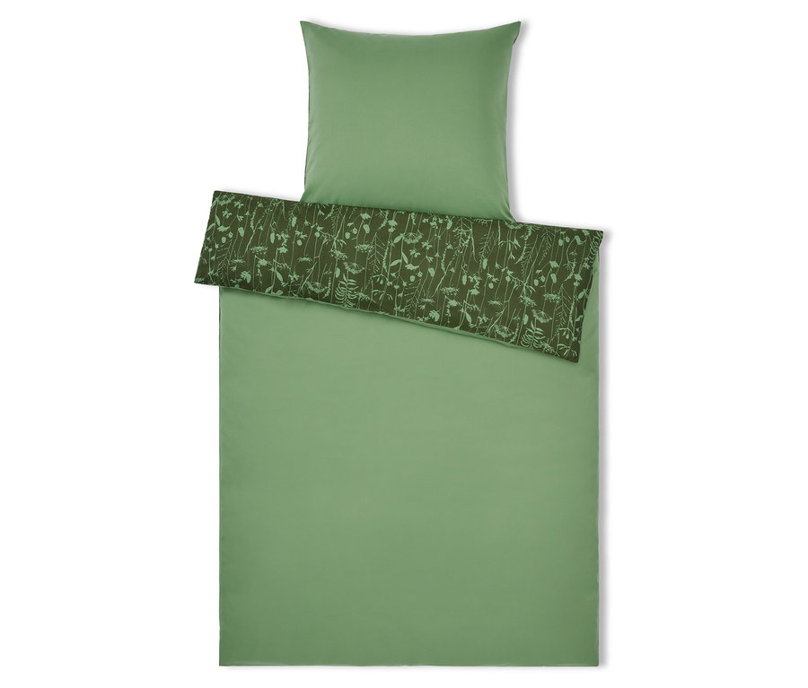 Zelené povlečení s květinovým vzorem a polštář nahoře.